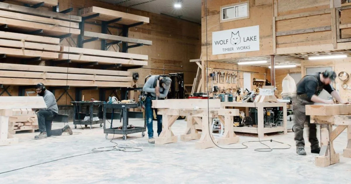 Craftsmen building custom timber structures in workshop